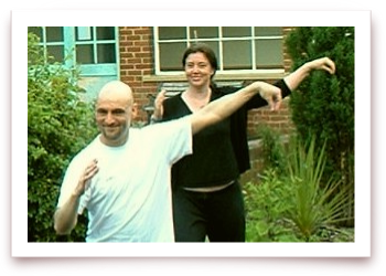 photo of man & woman practicing Tai Chi form
